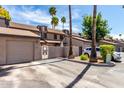 Inviting townhome exterior featuring a private garage, gated courtyard entry, and mature trees at 2232 W Lindner Ave # 20, Mesa, AZ 85202