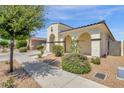 Charming single-story home with a two-car garage, arched entryway, and well-maintained front yard at 22472 E Sonoqui Blvd, Queen Creek, AZ 85142