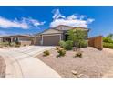 Charming home featuring a three-car garage, neutral paint, and desert landscaping at 2458 N Abbey Rd, Casa Grande, AZ 85122