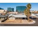 Expansive aerial view of the cozy one-story home with city views and a palm tree lined street at 2544 E Elm St, Phoenix, AZ 85016