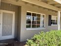 Inviting front porch with a storm door and a view of the well-maintained landscaping around the property at 2544 E Elm St, Phoenix, AZ 85016