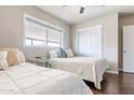 Bright bedroom with two beds, dark wood floor and closet at 2715 E Edgemont Ave, Phoenix, AZ 85008