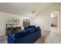 Bright living room with vaulted ceilings, and comfortable blue sofa, perfect for relaxation at 3015 S Woodruff Dr, Mesa, AZ 85212