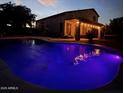Inviting backyard pool illuminated at night, perfect for relaxation and entertaining with its tranquil ambiance at 345 N Scott Dr, Chandler, AZ 85225