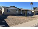 Traditional single story home with tan brick and attached two car garage and freshly xeriscaped front yard at 3539 W Davidson Ln, Phoenix, AZ 85051