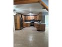 Bright kitchen featuring wooden cabinets, modern stainless steel appliances, and tile flooring at 3539 W Davidson Ln, Phoenix, AZ 85051