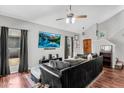 Spacious living room with vaulted ceilings, hardwood floors, comfortable seating, and a modern entertainment setup at 3608 W Harrison St, Chandler, AZ 85226