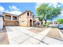 Spacious home showcasing a long driveway leading to a two-car garage and well-maintained landscaping at 3745 E Flamingo Way, Gilbert, AZ 85297