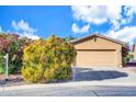 Charming single-story home featuring a two-car garage, desert landscaping, and a well-manicured front yard at 42318 W Abbey Rd, Maricopa, AZ 85138