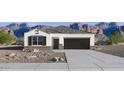 Charming single-story home with a well-maintained front yard and a two-car garage at 5106 E Midnight Star Dr, San Tan Valley, AZ 85143