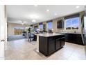 Bright, open-concept kitchen featuring granite countertops, an island, and seamless access to the living and dining areas at 5106 E Midnight Star Dr, San Tan Valley, AZ 85143