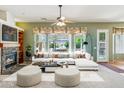 Spacious living room with fireplace, large windows, and comfortable seating at 8046 W Yukon Dr, Peoria, AZ 85382