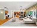 Open-concept living room with fireplace, built-in shelves, and adjacent desk area at 8046 W Yukon Dr, Peoria, AZ 85382