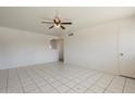 Spacious living area with tile flooring, neutral walls, and a ceiling fan providing ample natural light at 946 S Pomeroy Cir, Mesa, AZ 85210