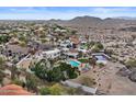 Expansive property featuring a pool, sport court, and lush landscaping in a scenic desert neighborhood at 11809 S Montezuma Ct, Phoenix, AZ 85044