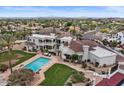 Luxury home with a private pool, manicured lawn, and balcony overlooking a sprawling landscape at 11809 S Montezuma Ct, Phoenix, AZ 85044