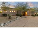 Landscaped front yard with rock garden design and an inviting walkway to the front door at 12006 E Yucca St, Scottsdale, AZ 85259