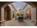 Inviting outdoor patio with a stone fireplace and comfortable seating area at 12006 E Yucca St, Scottsdale, AZ 85259