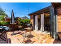 Inviting backyard patio featuring a tiled floor, comfortable seating, string lights, and access to the house at 1246 E Cambridge Ave, Phoenix, AZ 85006