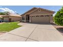 Inviting one-story home with a lush green lawn and extended driveway at 137 W Del Rio St, Gilbert, AZ 85233