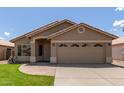 Single-story home featuring a two-car garage, neutral exterior, and well-maintained landscaping at 137 W Del Rio St, Gilbert, AZ 85233