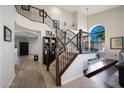 Grand foyer with staircase, iron railings, soaring ceilings, and large windows with beautiful natural light at 14034 S 34Th Pl, Phoenix, AZ 85044