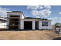 New home under construction with tile roof and open garage bays at 15785 W Cheryl Dr, Waddell, AZ 85355
