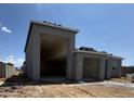 New house showing exterior stucco construction and an oversized two-car garage at 15785 W Cheryl Dr, Waddell, AZ 85355