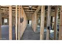 Interior view of new home framing with a long hallway to exterior at 15785 W Cheryl Dr, Waddell, AZ 85355