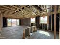 Unfinished living room with wooden framing, exposed ceiling, and slider door at 15785 W Cheryl Dr, Waddell, AZ 85355