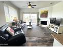 Inviting living room with wood floors, fireplace, and sliding glass doors to the outside patio at 16013 S Desert Foothills Pkwy # 2056, Phoenix, AZ 85048