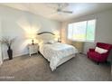 Cozy main bedroom with carpeted floors, neutral walls, and matching bedside tables with lamps at 16013 S Desert Foothills Pkwy # 2056, Phoenix, AZ 85048