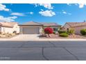 Charming single-story home featuring a two-car garage and colorful desert landscaping at 16246 W Talara Way, Surprise, AZ 85374