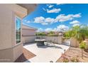Private patio features a charming fire pit area, desert landscaping, and a partial view at 16246 W Talara Way, Surprise, AZ 85374
