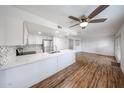 Stylish kitchen featuring white cabinetry, stainless steel appliances, and a center island with marble countertop at 18811 N 19Th Ave # 2020, Phoenix, AZ 85027