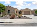 Charming single-story home featuring a desert landscape, tile roof, and attached garage, offering great curb appeal at 20655 N 273Rd Ave, Buckeye, AZ 85396