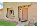 Charming exterior of the home with decorative brick accents and inviting front door at 225 N Standage -- # 139, Mesa, AZ 85201