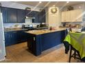 Modern kitchen boasts an island with granite counters, stainless steel appliances, and ample cabinet storage at 23644 S 209Th Pl, Queen Creek, AZ 85142