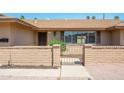Close-up of the front entrance, showcasing the gated entry and desert landscaping at 2418 E Huntington Dr, Tempe, AZ 85282
