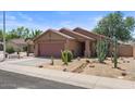 Single-story home with desert landscaping, covered porch, and two-car garage at 2467 E Winchester Pl, Chandler, AZ 85286