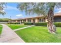 Street view of a row of well-kept homes, each with green lawns and manicured bushes at 2528 N 22Nd Dr, Phoenix, AZ 85009