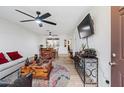 Bright living room featuring modern decor, a ceiling fan, and a comfortable seating arrangement at 2528 N 22Nd Dr, Phoenix, AZ 85009