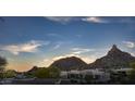 Desert property featuring mountain views in the background at sunset at 26049 N 104Th Pl, Scottsdale, AZ 85255
