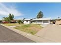 Traditional single-story home with a well-manicured front lawn and attached garage at 2740 N 21St Dr, Phoenix, AZ 85009