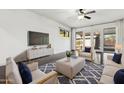 Elegantly furnished living room featuring modern decor, a plush rug, and a large TV for entertainment at 2740 N 21St Dr, Phoenix, AZ 85009