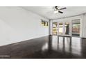 Bright living room with sleek concrete floors, contemporary lighting, and access to the backyard at 2740 N 21St Dr, Phoenix, AZ 85009