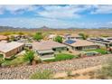 A sunny aerial view of home with manicured back yard landscaping in a residential neighborhood at 30909 N 27Th Ave, Phoenix, AZ 85085