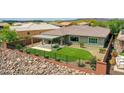 Private backyard oasis with synthetic grass, covered patio, and privacy fence in a desert landscape at 30909 N 27Th Ave, Phoenix, AZ 85085