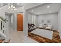 Welcoming foyer boasts a curved staircase, wood floors, and ample natural light streaming through plantation shutters at 3603 E Salter Dr, Phoenix, AZ 85050
