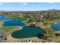 A beautiful aerial view of a golf course with water features on a sunny day at 3671 S Greythorne Way, Chandler, AZ 85248